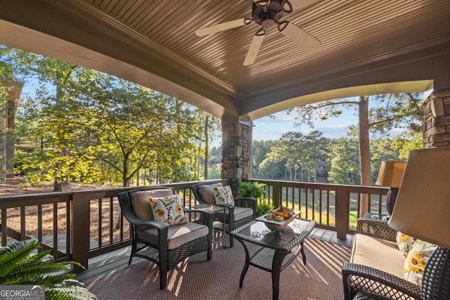 wooden terrace featuring an outdoor hangout area and ceiling fan