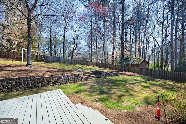 view of yard with a playground and a fenced backyard