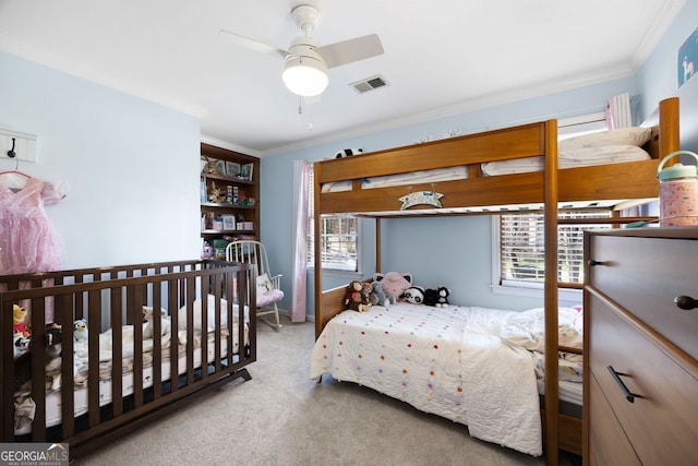 carpeted bedroom with visible vents and crown molding