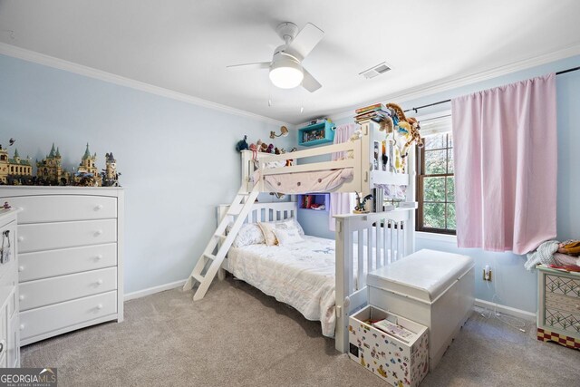 carpeted bedroom with ceiling fan, visible vents, baseboards, and ornamental molding