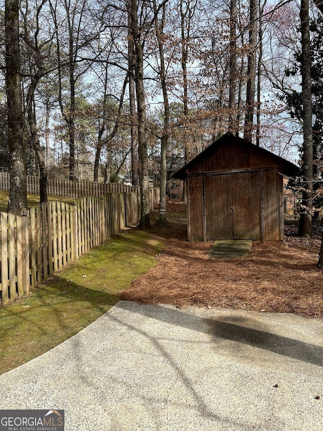 view of yard with fence private yard and an outdoor structure