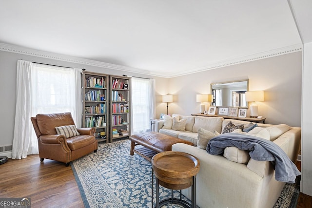 living area featuring wood finished floors and ornamental molding