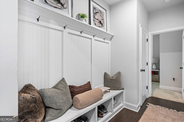 mudroom featuring baseboards and dark wood-style flooring