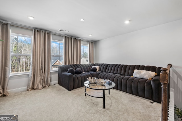 living room with recessed lighting, carpet floors, visible vents, and baseboards