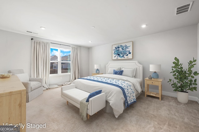 bedroom with light carpet, visible vents, and recessed lighting