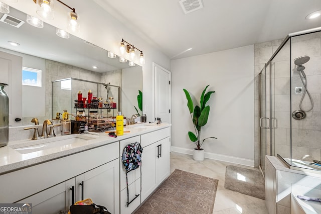 bathroom with visible vents, a sink, and a shower stall