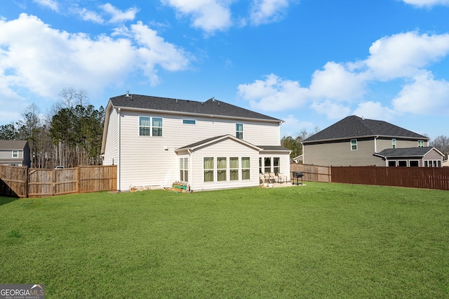 back of house with a lawn, a fenced backyard, and a patio