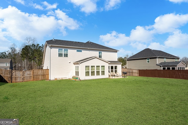 back of property with a lawn, a fenced backyard, and a patio area