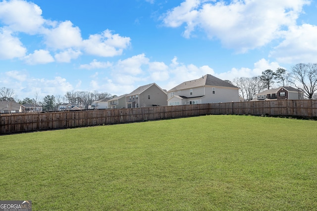 view of yard featuring a residential view and fence