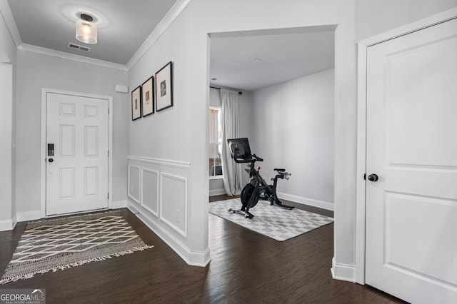 entryway with visible vents, baseboards, dark wood-style floors, and crown molding