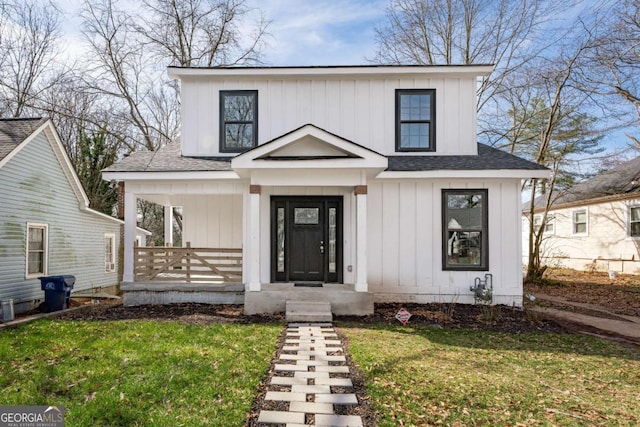 modern farmhouse with a front lawn, covered porch, board and batten siding, and roof with shingles