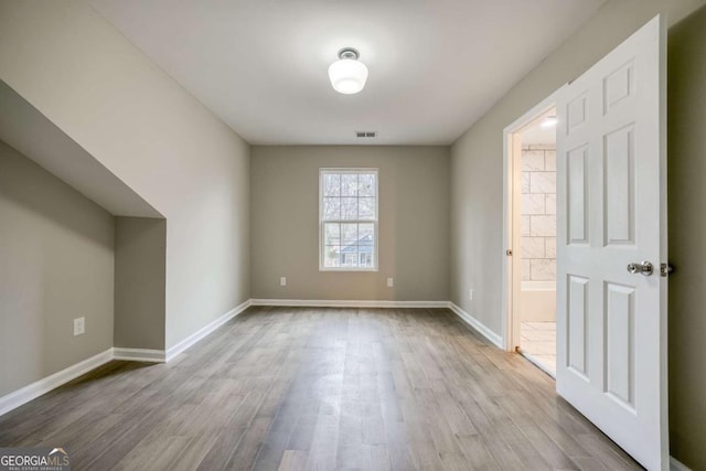 bonus room featuring wood finished floors, visible vents, and baseboards