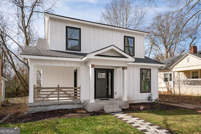 modern inspired farmhouse featuring covered porch, board and batten siding, and a shingled roof