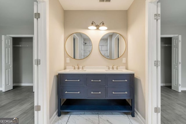 bathroom featuring visible vents, baseboards, and a sink