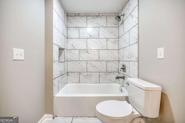 full bath with marble finish floor, toilet, and shower / bath combination