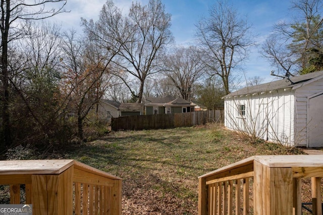 view of yard featuring an outdoor structure and fence