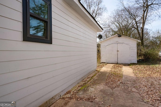 view of side of property with an outbuilding and a shed