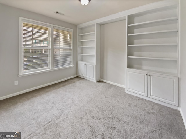 interior space with visible vents, baseboards, and carpet