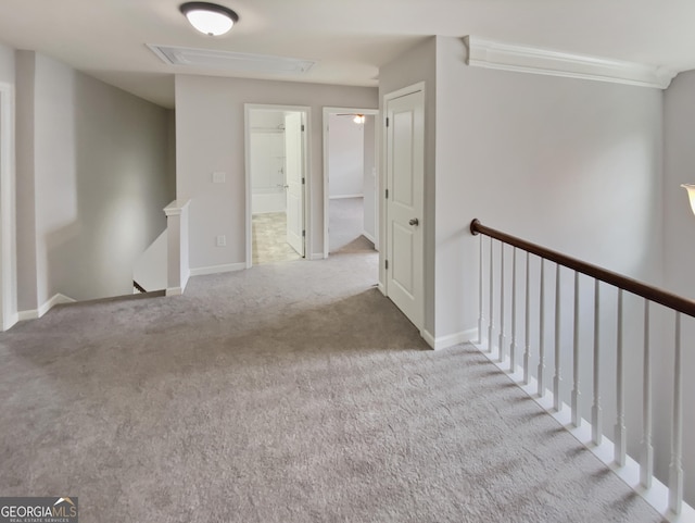 hall featuring carpet, an upstairs landing, and baseboards