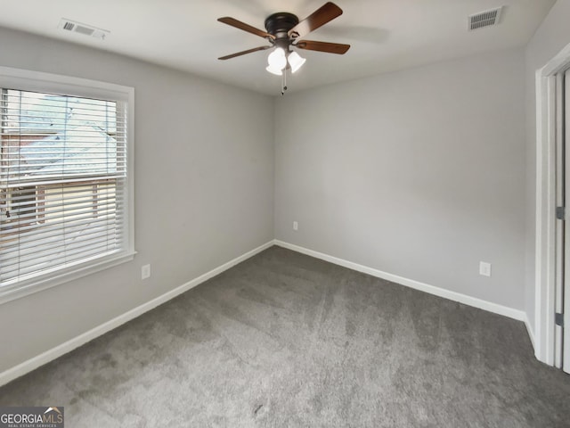 carpeted empty room featuring visible vents, baseboards, and ceiling fan