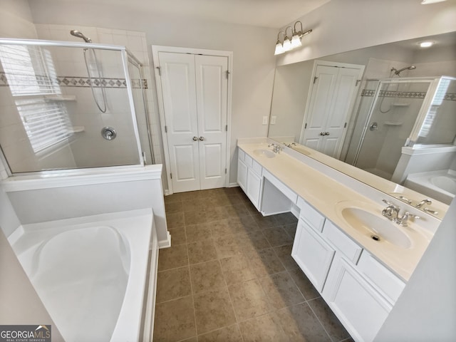 bathroom featuring a sink, double vanity, a bath, and a shower stall