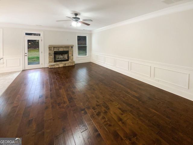 unfurnished living room with ceiling fan, dark wood-style floors, a fireplace, and crown molding