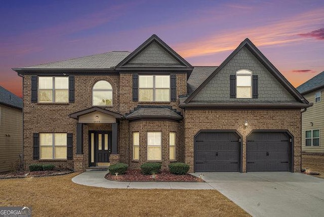 view of front of home with brick siding and concrete driveway