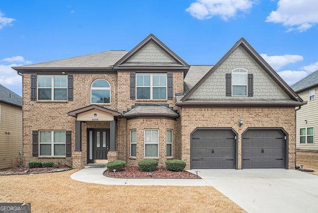 view of front of home with brick siding, driveway, and a garage