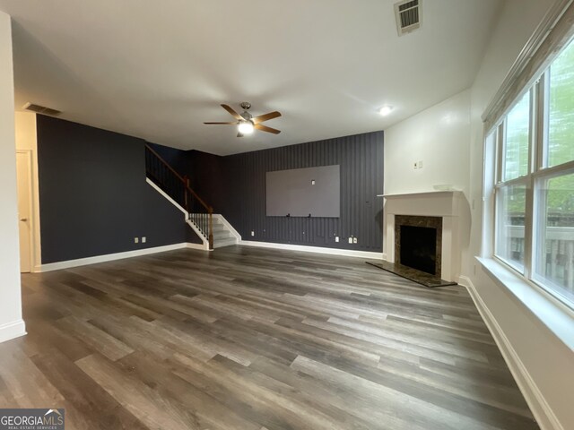 5928 Cobblestone Creek Cir, Mableton, GA 30126 - unfurnished living room with an accent wall, a ceiling fan, visible vents, stairway, and wood finished floors