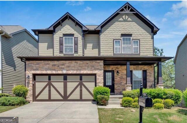 5928 Cobblestone Creek Cir, Mableton, GA 30126 - craftsman inspired home featuring concrete driveway, stone siding, and an attached garage