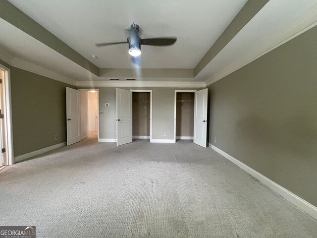 5928 Cobblestone Creek Cir, Mableton, GA 30126 - unfurnished bedroom with baseboards, two closets, and a raised ceiling