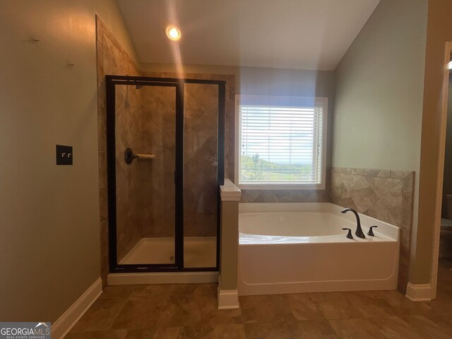 5928 Cobblestone Creek Cir, Mableton, GA 30126 - bathroom with a shower stall, a bath, baseboards, and vaulted ceiling