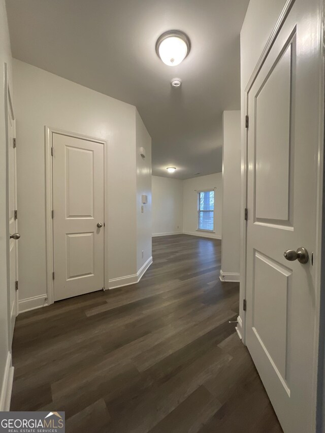 5928 Cobblestone Creek Cir, Mableton, GA 30126 - hallway with baseboards and dark wood finished floors