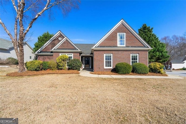 traditional home featuring brick siding and a front lawn