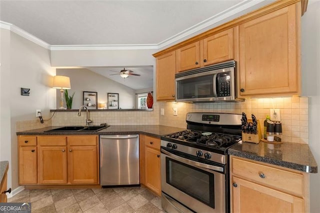 kitchen with a sink, stainless steel appliances, decorative backsplash, and vaulted ceiling