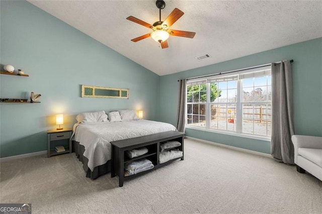 bedroom with carpet flooring, a textured ceiling, baseboards, and lofted ceiling