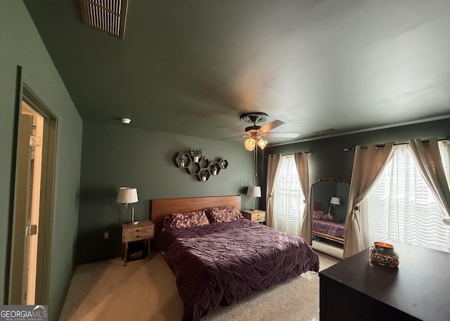 bedroom with a ceiling fan, carpet, and visible vents