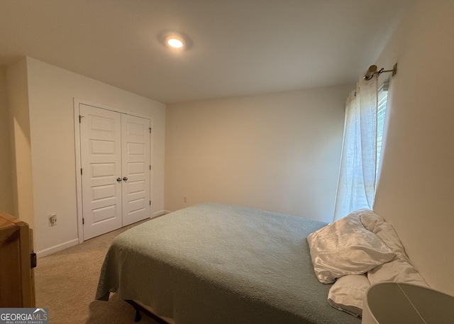 bedroom with a closet, baseboards, and carpet