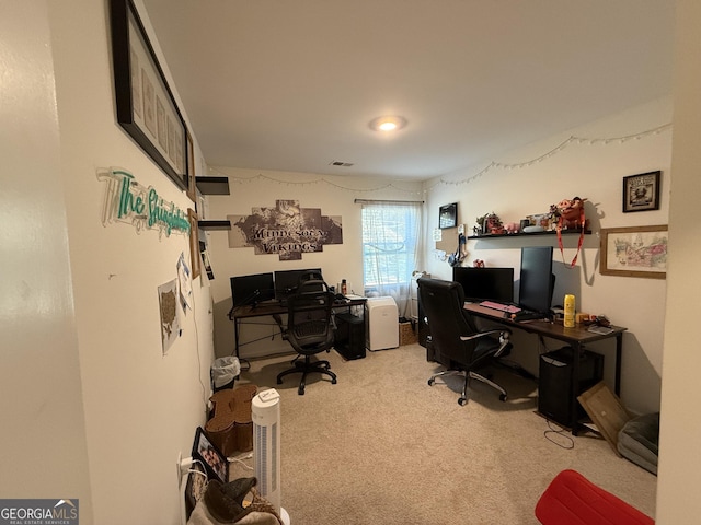 office area with visible vents and carpet floors