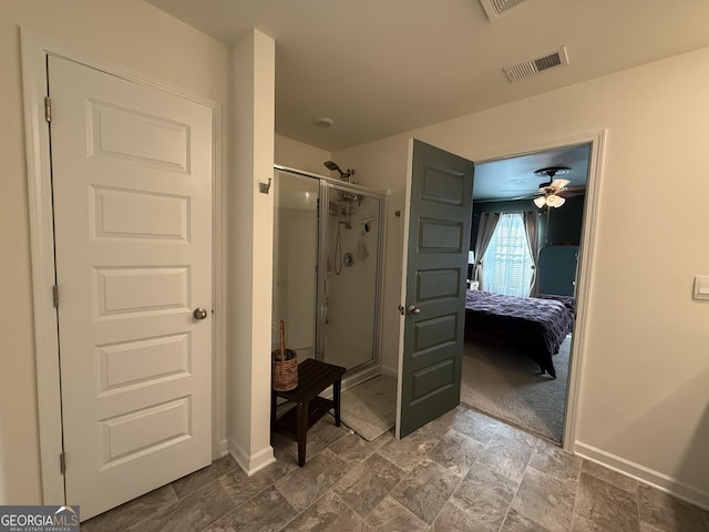 ensuite bathroom with baseboards, visible vents, ensuite bath, a shower stall, and stone finish flooring