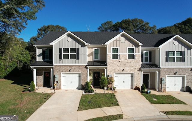 townhome / multi-family property featuring board and batten siding, driveway, and a standing seam roof