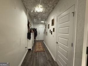 hallway with dark wood-type flooring and baseboards