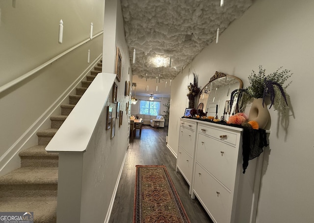 hallway featuring stairway and dark wood-style flooring