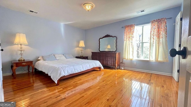 bedroom with visible vents, baseboards, and wood-type flooring