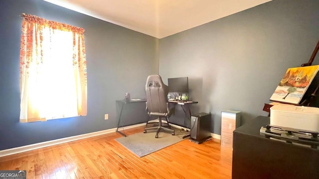 office featuring hardwood / wood-style flooring and baseboards