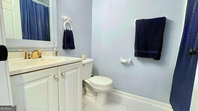 full bathroom with baseboards, toilet, vanity, and tile patterned flooring