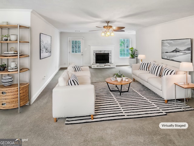 living room with ornamental molding, a ceiling fan, baseboards, and a premium fireplace