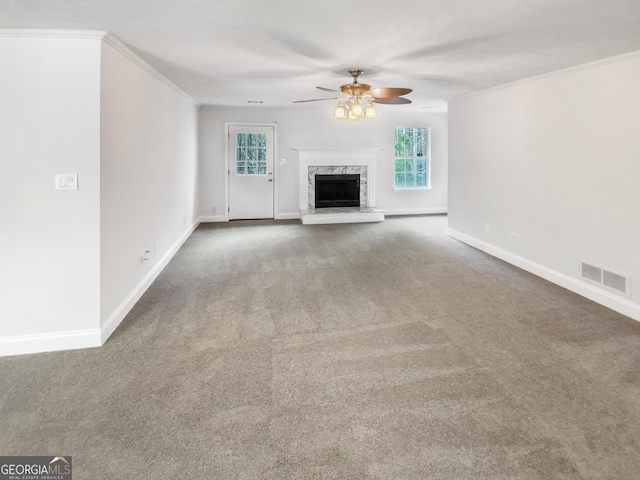 unfurnished living room with visible vents, ceiling fan, baseboards, carpet flooring, and a fireplace