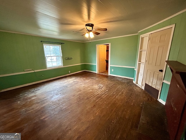 unfurnished bedroom featuring hardwood / wood-style flooring, a ceiling fan, baseboards, and ornamental molding