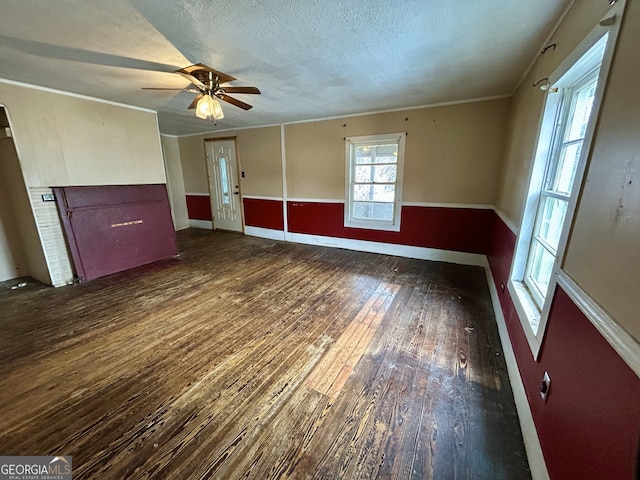 unfurnished living room featuring a ceiling fan, a textured ceiling, hardwood / wood-style floors, and crown molding